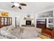 Open concept living room boasts carpet flooring, a fireplace, and natural lighting at 11866 N 143Rd Ave, Surprise, AZ 85379