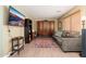 Comfortable living room featuring modern laminate floors, a large sofa, and a wooden armoire at 11866 N 143Rd Ave, Surprise, AZ 85379