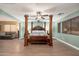 Bright main bedroom features a four-poster bed, wood flooring, and an open concept design at 11866 N 143Rd Ave, Surprise, AZ 85379