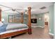 Spacious main bedroom features a four-poster bed, wood flooring, and a private fireplace at 11866 N 143Rd Ave, Surprise, AZ 85379