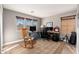 Cozy home office featuring three windows, a rocking chair, an area rug, and a built-in desk setup at 11866 N 143Rd Ave, Surprise, AZ 85379