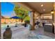 Charming covered patio with barbeque, outdoor lighting, and a view of the sparkling pool at 11866 N 143Rd Ave, Surprise, AZ 85379