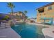 Backyard swimming pool with waterfalls, palm trees, and patio area at 12017 W Monte Lindo Ln, Sun City, AZ 85373