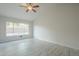 Bedroom showcases natural light with a ceiling fan and window offering backyard views and complementing tiled floors at 1225 E San Angelo Ave, Gilbert, AZ 85234