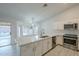 Modern kitchen with white cabinets, quartz countertops, and stainless steel appliances at 1225 E San Angelo Ave, Gilbert, AZ 85234