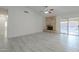 Open living area featuring stone fireplace and glass sliding doors to the backyard at 1225 E San Angelo Ave, Gilbert, AZ 85234