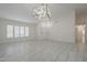 Spacious living room with vaulted ceiling, stylish light fixture and tile floors at 1225 E San Angelo Ave, Gilbert, AZ 85234