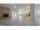Cozy living space featuring fireplace, sliding doors and view of the kitchen at 1225 E San Angelo Ave, Gilbert, AZ 85234