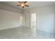 Spacious main bedroom with updated floors, featuring neutral walls with ensuite bathroom access, and a ceiling fan at 1225 E San Angelo Ave, Gilbert, AZ 85234
