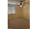 Comfortable bedroom with a ceiling fan, plush carpet, and a window at 12848 W Desert Mirage Dr, Peoria, AZ 85383