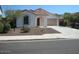 Charming single-story home featuring a well-maintained front yard and inviting entrance at 12848 W Desert Mirage Dr, Peoria, AZ 85383