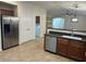 Modern kitchen with stainless steel appliances, sleek countertops, and a breakfast bar at 12848 W Desert Mirage Dr, Peoria, AZ 85383