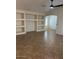 Open-concept living room with built-in shelves and neutral color palette at 12848 W Desert Mirage Dr, Peoria, AZ 85383