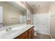Bright bathroom featuring a sink, white countertop, and a shower/tub combination with white tile at 1370 S 228Th Ln, Buckeye, AZ 85326
