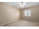 Neutral carpeted bedroom with a ceiling fan and bright window at 1370 S 228Th Ln, Buckeye, AZ 85326