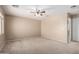 Spacious bedroom with neutral carpet, a ceiling fan, and an entrance to another room at 1370 S 228Th Ln, Buckeye, AZ 85326
