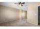 Cozy bedroom with neutral carpet, ceiling fan, and sliding mirrored closet doors at 1370 S 228Th Ln, Buckeye, AZ 85326
