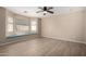 Bright bedroom with wood flooring, a ceiling fan, and a cozy window seat for relaxing at 1370 S 228Th Ln, Buckeye, AZ 85326