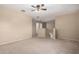 Spacious bonus room features neutral carpet, a ceiling fan, and stair access at 1370 S 228Th Ln, Buckeye, AZ 85326