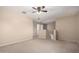 Bonus room features neutral carpet, a ceiling fan, and stair access to another level at 1370 S 228Th Ln, Buckeye, AZ 85326