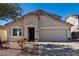Charming single-story home with a well-manicured front yard and a two-car garage at 1370 S 228Th Ln, Buckeye, AZ 85326