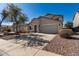 A well-kept home with desert landscaping, wide driveway, and a large attached garage at 1370 S 228Th Ln, Buckeye, AZ 85326