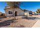 Cozy home featuring desert landscaping, a tree in the front yard, and attached garage at 1370 S 228Th Ln, Buckeye, AZ 85326