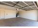 Spacious two car garage with door to exterior, painted drywall, and concrete floor at 1370 S 228Th Ln, Buckeye, AZ 85326
