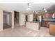 Inviting kitchen with stainless steel appliances, a kitchen island, and a staircase leading upstairs at 1370 S 228Th Ln, Buckeye, AZ 85326