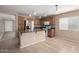 Well-lit kitchen boasts stainless appliances, wooden cabinets, and a functional island with counter seating at 1370 S 228Th Ln, Buckeye, AZ 85326