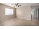 Inviting living room features light walls, a modern ceiling fan, and laminate wood flooring at 1370 S 228Th Ln, Buckeye, AZ 85326