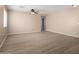 Open living room features light walls, modern ceiling fan, and beautiful laminate flooring at 1370 S 228Th Ln, Buckeye, AZ 85326