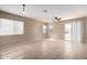 Spacious living room with tile floors, windows offering natural light, and sliding glass door at 1370 S 228Th Ln, Buckeye, AZ 85326