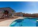 Backyard pool surrounded by a patio and protective fencing at 1370 S 228Th Ln, Buckeye, AZ 85326