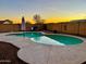Private backyard pool with desert landscaping and a brick wall at 1370 S 228Th Ln, Buckeye, AZ 85326