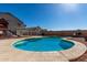 Backyard pool with attached spa, surrounded by a patio, and fencing at 1370 S 228Th Ln, Buckeye, AZ 85326