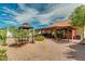 Spacious backyard with covered patio, gazebo, and gravel landscaping at 13830 W Fargo Dr, Surprise, AZ 85374
