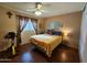 Well-lit bedroom with wood floors and exercise bike at 13830 W Fargo Dr, Surprise, AZ 85374
