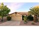 Tan house with tile roof, two-car garage, and desert landscaping at 13830 W Fargo Dr, Surprise, AZ 85374