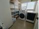 Laundry room with washer, dryer, and extra shelving at 13830 W Fargo Dr, Surprise, AZ 85374