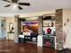 Living room with hardwood floors, fireplace, built-in entertainment center at 13830 W Fargo Dr, Surprise, AZ 85374