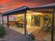 Evening view of patio with hot tub, seating area, and swing at 13830 W Fargo Dr, Surprise, AZ 85374