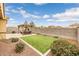 Landscaped backyard featuring a pergola with seating and an artificial turf area at 1437 W Smoke Tree Ave, San Tan Valley, AZ 85140