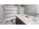 Bathroom featuring a double vanity with a white countertop and shower with decorative curtain at 1437 W Smoke Tree Ave, San Tan Valley, AZ 85140