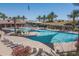 Community pool featuring large sunshade structures and ample lounge seating at 1437 W Smoke Tree Ave, San Tan Valley, AZ 85140