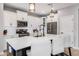 Modern kitchen features white cabinets, stainless steel appliances, a subway tile backsplash, and a spacious island with seating at 1437 W Smoke Tree Ave, San Tan Valley, AZ 85140