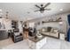 Spacious living room with a ceiling fan, and a view of the dining area at 1437 W Smoke Tree Ave, San Tan Valley, AZ 85140