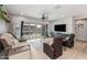 Comfortable living room with large sliding glass doors leading to the outdoor patio at 1437 W Smoke Tree Ave, San Tan Valley, AZ 85140
