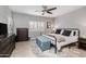 Serene main bedroom featuring neutral colors, a ceiling fan, ample closet space, and natural light at 1437 W Smoke Tree Ave, San Tan Valley, AZ 85140