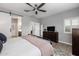Serene main bedroom features soft colors, wood-look tile floors, and a ceiling fan at 1437 W Smoke Tree Ave, San Tan Valley, AZ 85140